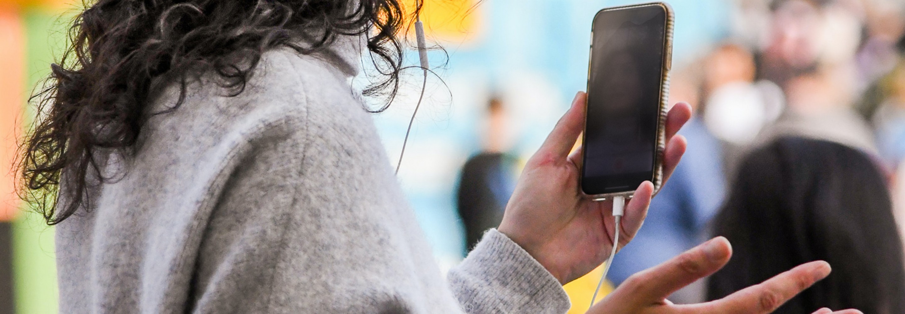 Woman talking on her cell phone and holding a basket; Photo by Heather McKean on Unsplash