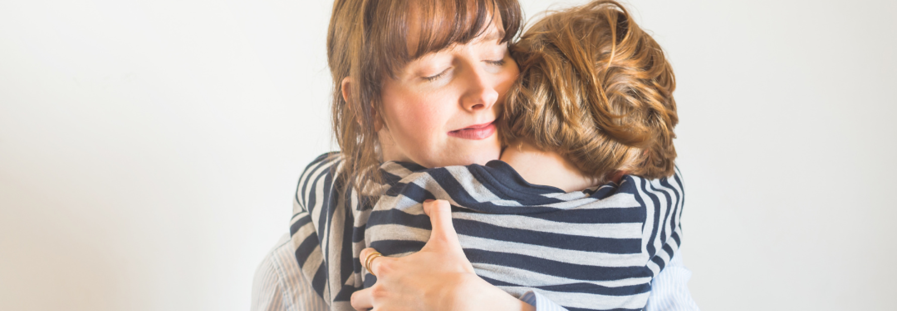 A mother hugs her child closely