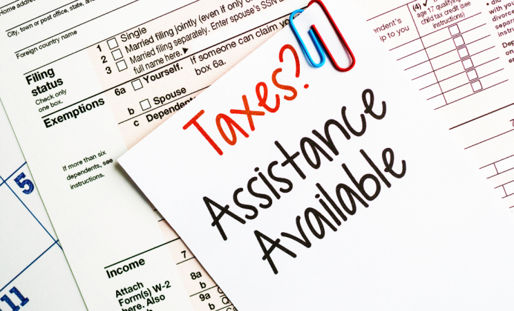 Tax forms that read "Taxes? Assistance Available"