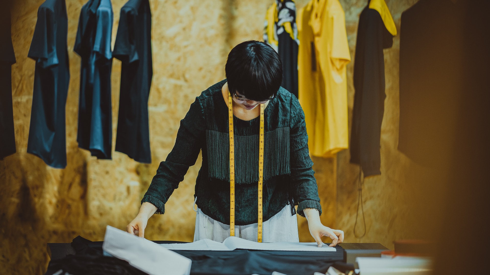 Seamstress working in a shop; Photo by Kenny Luo on Unsplash